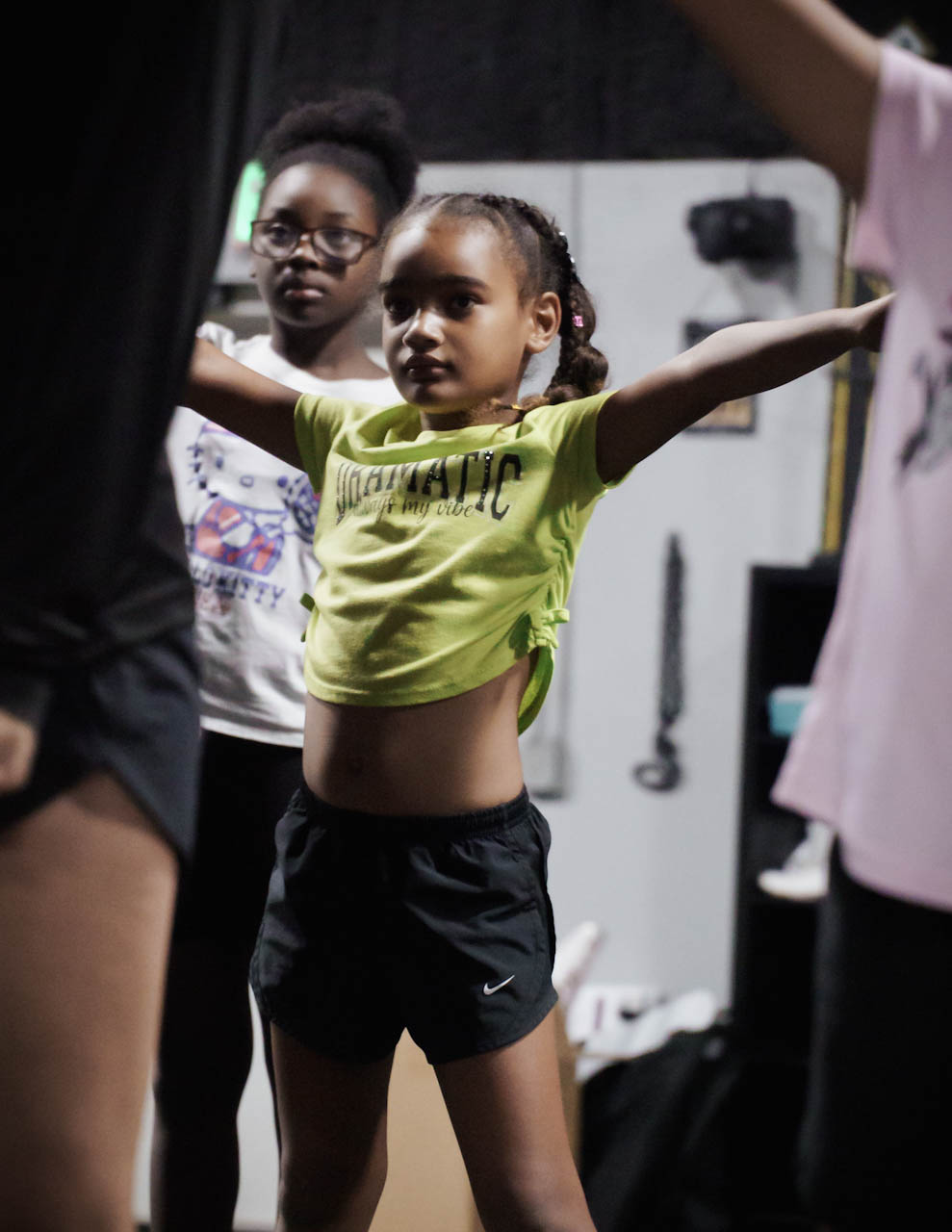 A young athlete practicing a strong cheer motion during Category 5 camp